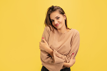 Image showing Portrait of young caucasian woman with bright emotions isolated on yellow studio background