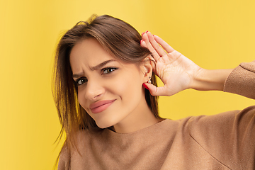 Image showing Portrait of young caucasian woman with bright emotions isolated on yellow studio background