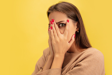 Image showing Portrait of young caucasian woman with bright emotions isolated on yellow studio background