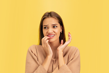 Image showing Portrait of young caucasian woman with bright emotions isolated on yellow studio background