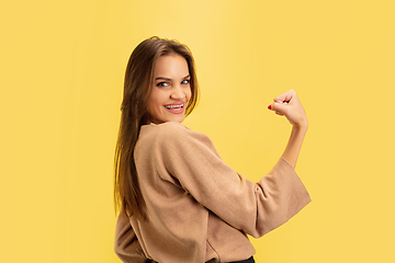 Image showing Portrait of young caucasian woman with bright emotions isolated on yellow studio background