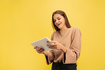 Image showing Portrait of young caucasian woman with bright emotions isolated on yellow studio background