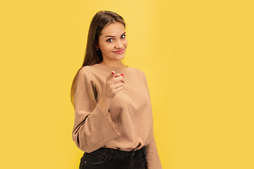 Image showing Portrait of young caucasian woman with bright emotions isolated on yellow studio background