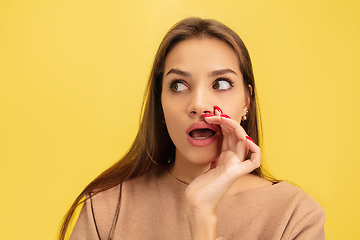 Image showing Portrait of young caucasian woman with bright emotions isolated on yellow studio background