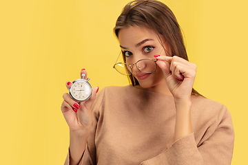 Image showing Portrait of young caucasian woman with bright emotions isolated on yellow studio background