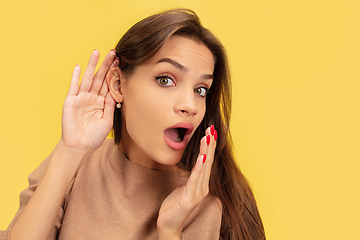 Image showing Portrait of young caucasian woman with bright emotions isolated on yellow studio background