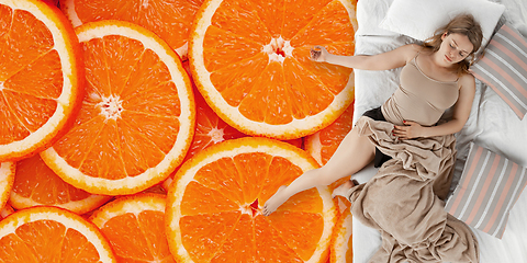 Image showing Portrait of a young girl sleeping and dreaming about oranges