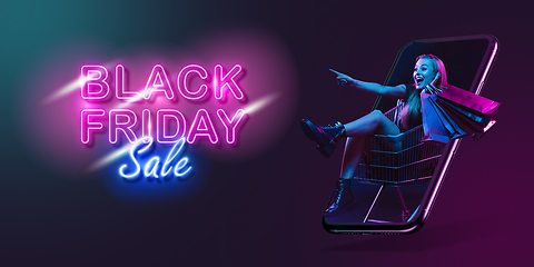 Image showing Beautiful woman inviting for shopping right from device screen, black friday, sales concept. Flyer with copyspace