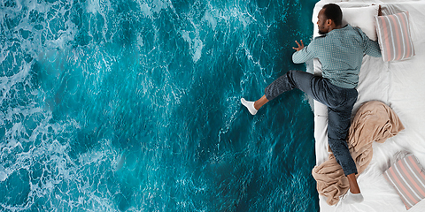 Image showing Portrait of a young man sleeping and dreaming about ocean and travel