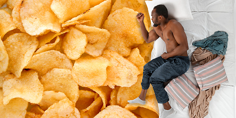 Image showing Portrait of a young man sleeping and dreaming about chips