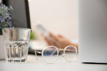 Image showing Remote working from home. Workplace in home office with PC, devices and gadgets.