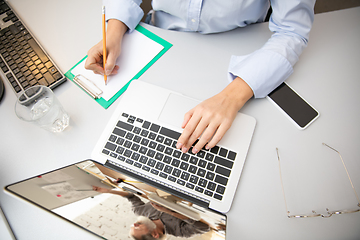 Image showing Remote working from home. Workplace in home office with PC, devices and gadgets.