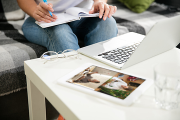 Image showing Remote working from home. Workplace in home office with PC, devices and gadgets.