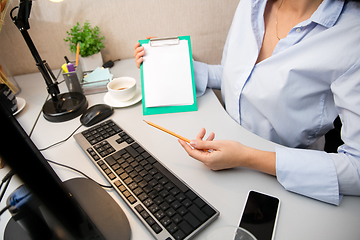 Image showing Remote working from home. Workplace in home office with PC, devices and gadgets.