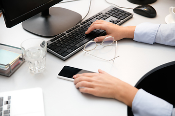 Image showing Remote working from home. Workplace in home office with PC, devices and gadgets.