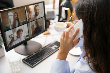 Image showing Remote working from home. Workplace in home office with PC, devices and gadgets.