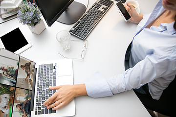 Image showing Remote working from home. Workplace in home office with PC, devices and gadgets.