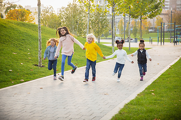 Image showing Interracial group of kids, girls and boys playing together at the park in summer day