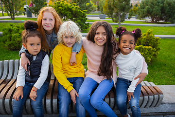 Image showing Interracial group of kids, girls and boys playing together at the park in summer day