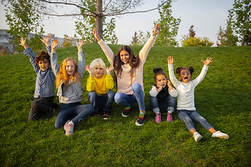 Image showing Interracial group of kids, girls and boys playing together at the park in summer day