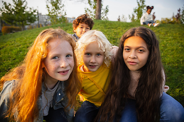 Image showing Interracial group of kids, girls and boys playing together at the park in summer day