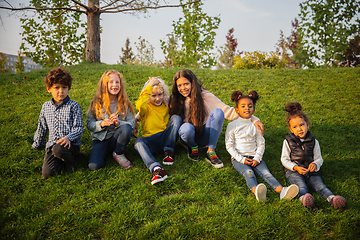 Image showing Interracial group of kids, girls and boys playing together at the park in summer day