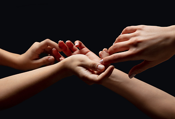 Image showing Hands of people\'s crowd in touch isolated on black studio background. Concept of human relation, community, togetherness, symbolism