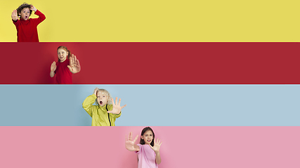 Image showing Young happy caucasian kids gesturing isolated on multicolored studio background. Human emotions, facial expression concept. Collage