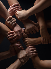 Image showing Hands of people\'s crowd in touch isolated on black studio background. Concept of human relation, community, togetherness, symbolism