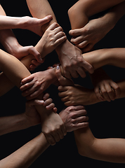 Image showing Hands of people\'s crowd in touch isolated on black studio background. Concept of human relation, community, togetherness, symbolism