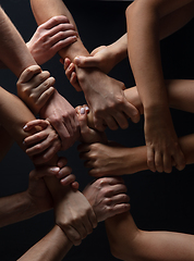 Image showing Hands of people\'s crowd in touch isolated on black studio background. Concept of human relation, community, togetherness, symbolism