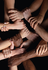 Image showing Hands of people\'s crowd in touch isolated on black studio background. Concept of human relation, community, togetherness, symbolism