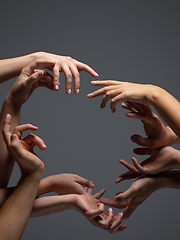 Image showing Hands of people\'s crowd in touch isolated on grey studio background. Concept of human relation, community, togetherness, symbolism