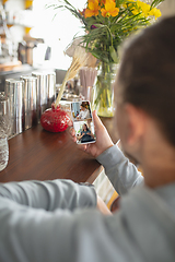 Image showing Remote working. Workplace in bar, restaurant office with PC, devices and gadgets.