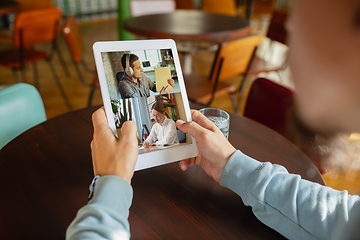 Image showing Remote working. Workplace in bar, restaurant office with PC, devices and gadgets.