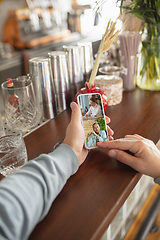 Image showing Remote working. Workplace in bar, restaurant office with PC, devices and gadgets.