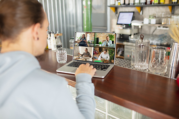 Image showing Remote working. Workplace in bar, restaurant office with PC, devices and gadgets.