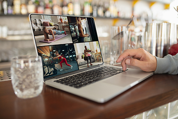 Image showing Remote working. Workplace in bar, restaurant office with PC, devices and gadgets.