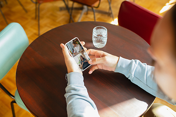 Image showing Remote working. Workplace in bar, restaurant office with PC, devices and gadgets.