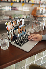 Image showing Remote working. Workplace in bar, restaurant office with PC, devices and gadgets.