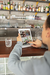 Image showing Remote working. Workplace in bar, restaurant office with PC, devices and gadgets.