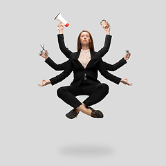 Image showing Beautiful business woman, secretary, multi-armed manager levitating isolated on grey studio background