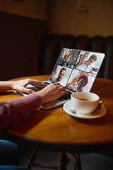 Image showing Remote working. Workplace in bar, restaurant office with PC, devices and gadgets.