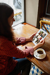 Image showing Remote working. Workplace in bar, restaurant office with PC, devices and gadgets.