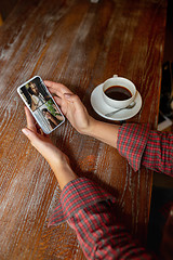 Image showing Remote working. Workplace in bar, restaurant office with PC, devices and gadgets.