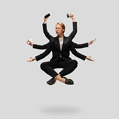 Image showing Beautiful business woman, secretary, multi-armed manager levitating isolated on grey studio background