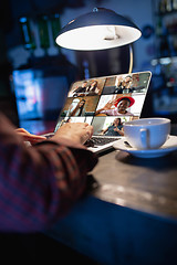 Image showing Remote working. Workplace in bar, restaurant office with PC, devices and gadgets.