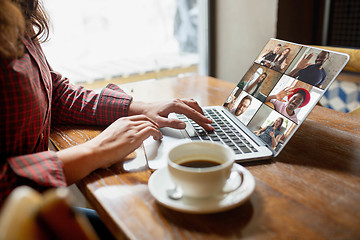 Image showing Remote working. Workplace in bar, restaurant office with PC, devices and gadgets.