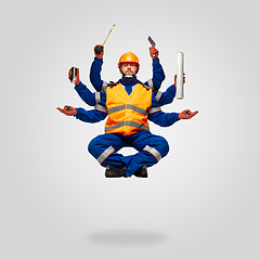 Image showing Handsome contractor, multi-armed builder levitating isolated on grey studio background