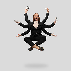 Image showing Beautiful business woman, secretary, multi-armed manager levitating isolated on grey studio background